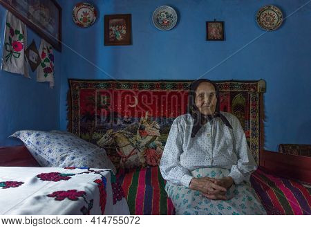 Salaj, Transylvania, Romania-may 14, 2018: Very Old Woman Sitting Alone Inside Her Little Charming H