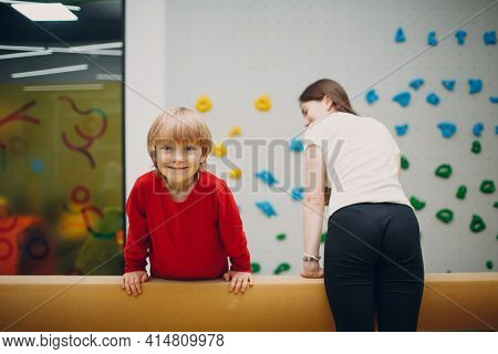 Kids Doing Balance Beam Gymnastics Exercises In Gym At Kindergarten Or Elementary School. Children S