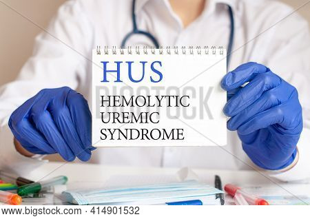 Hus Card In Hands Of Medical Doctor. Doctor's Hands In Blue Gloves Holding A Sheet Of Paper With Tex