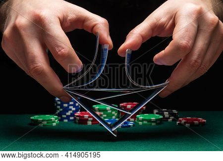 Close-up Hands Of A Person-dealer Or Croupier Shuffling Poker Cards In Casino On The Background Of A