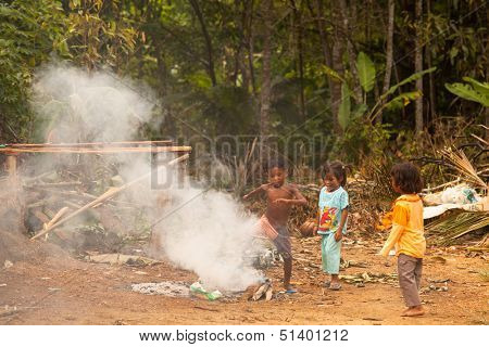 BERDUT, MALAYSIA - APR 8: Unidentified children Orang Asli in his village on Apr 8, 2013 in Berdut, Malaysia. More than 76% of all Orang Asli live below the poverty line, life expectancy- 53 years old