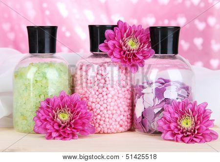 Aromatherapy minerals - colorful bath salt on pink background