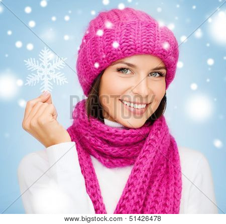 winter, people, happiness concept - woman in hat and muffler with big snowflake