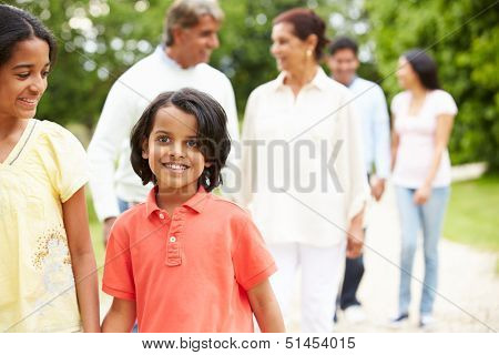 Muti-Generation Indian Family Walking In Countryside
