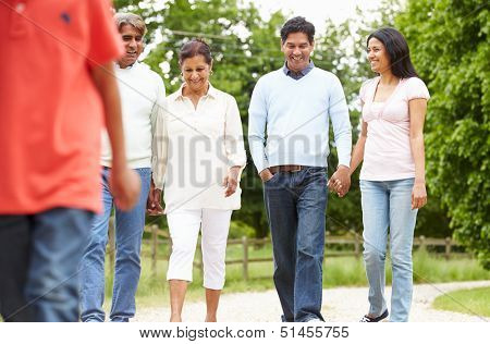 Muti-Generation Indian Family Walking In Countryside