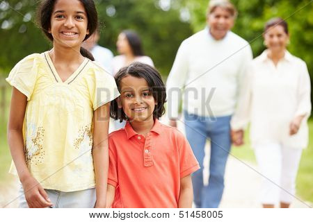 Muti-Generation Indian Family Walking In Countryside