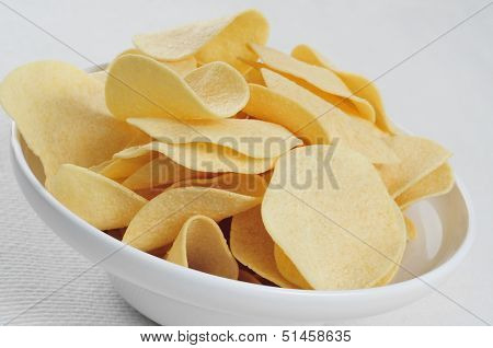 closeup of a bowl with low fat potato chips on a table