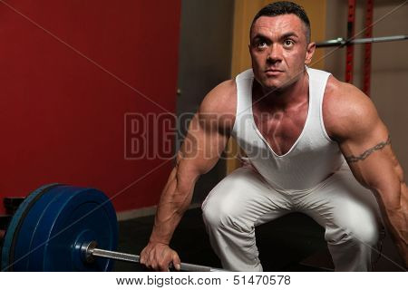 Bodybuilder Preparing For Deadlift Of Barbell