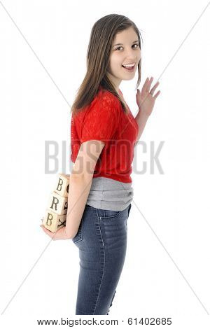 A happy young teen waving good-bye as she holds alphabet blocks showing the letters 