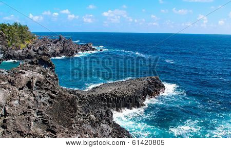 Sea waves crashing on cliffs