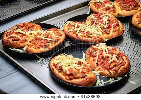 almost ready hot juicy mini pizzas before cheese melted