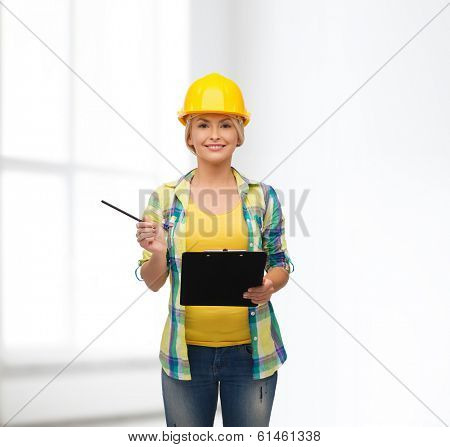 repair, construction and maintenance concept - smiling woman in helmet with clipboard