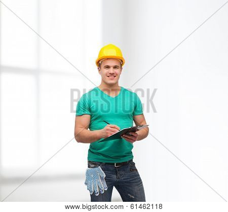 repair, construction and maintenance concept - smiling man in helmet with clipboard