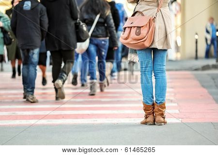 Close-up of woman legs waiting at a pedestrian crossing