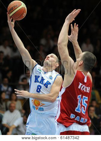 KAPOSVAR, HUNGARY - MARCH 8: Marton Fodor (white 8) in action at a Hungarian Championship basketball game with Kaposvar (white) vs. Paks (red) on March 8, 2014 in Kaposvar, Hungary.