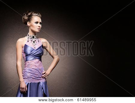 Portrait of young, attractive and gorgeous woman in jewels over luxury background