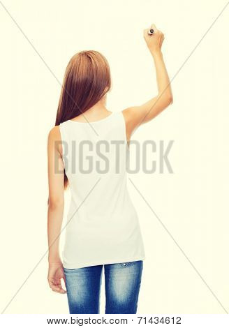 shirt design and advertisement concept - teenage girl in blank white shirt from the back drawing or writing something in the air