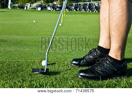 Golf Player Putting The Ball