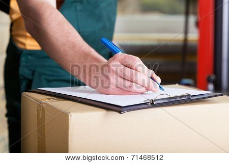 Man's Hand Signing Delivery Document