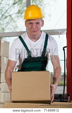Portrait Of A Warehouse Worker Lifting A Box