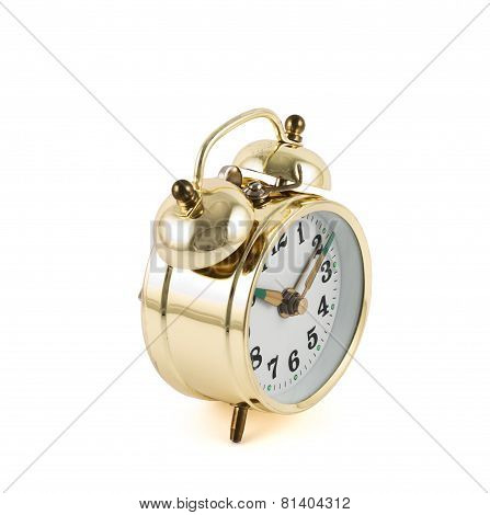 Golden mechanical alarm clock isolated