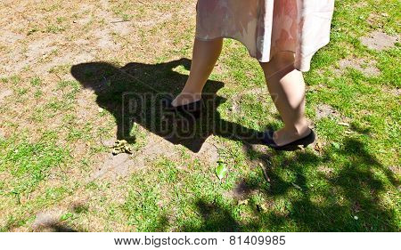 Leg Of Beautiful Girl Walking On The Green