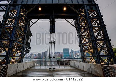 Manhattan New York cloudy skyline from East River floodgates structure USA