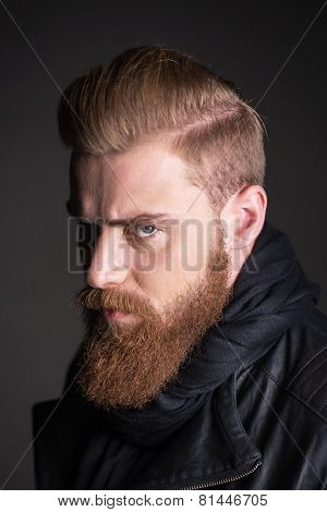 Young man with beard looking at camera