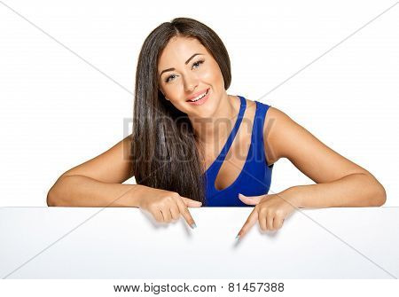 Young pretty woman peeking out from behind the wall