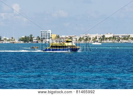 ISLA MUJERES - JANUARY 21: Ferry boat with tourists on 21 January 2015 in Isla Mujeres, Mexico. The island is located 8 miles east of Cancun in the Gulf of Mexico.