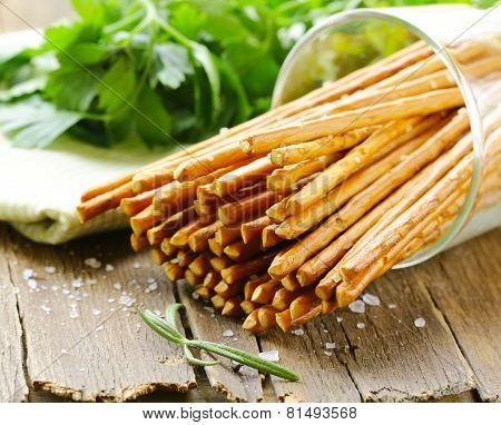salty pretzel snack sticks in a glass on the table