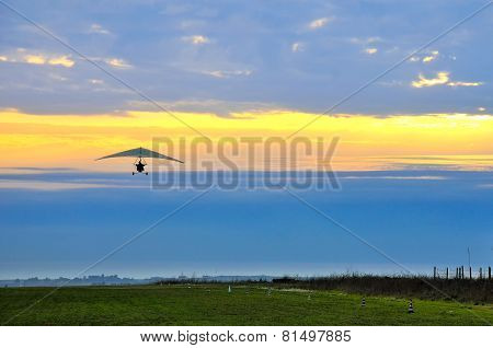 Motor Hang Glider In The Cloudy Sunset