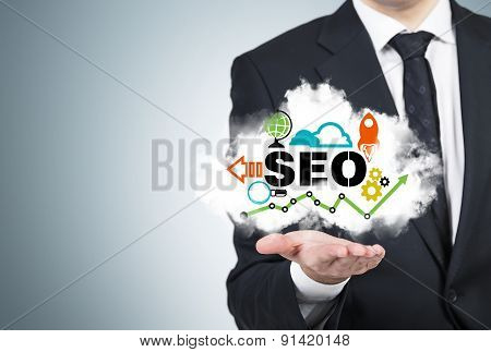 A Manager Is Holding A Cloud With The Seo Cloud.