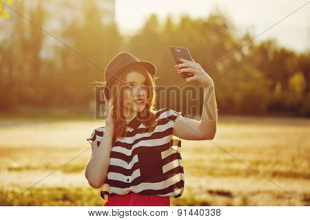 Lovely Girl In A Hat On The Street Makes Selfei
