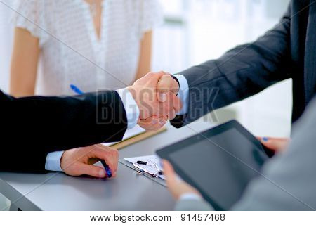 Business people shaking hands, finishing up a meeting