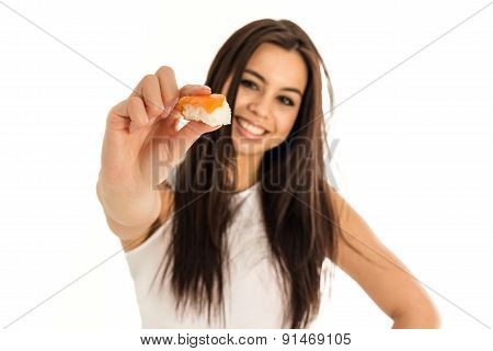 Young attractive woman holding sushi with her fingers