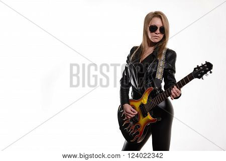 Sexy blonde girl in sunglasses black leather jacket playing black electric guitar