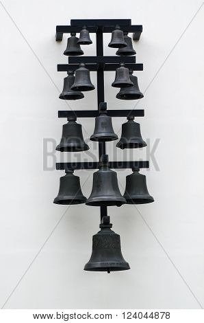 A lot of iron black bells on the white wall
** Note: Visible grain at 100%, best at smaller sizes