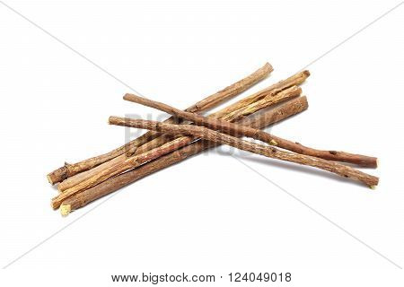 Licorice root lying on a white background