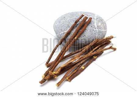 Licorice root lying on a white background