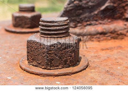 Old rusty metal nuts locked with rust and corrosion old bolts. Close up.