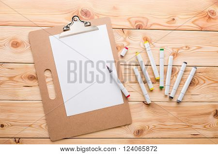Wooden office table notebooks and coloured markers on it. Concept of work. 3D rendering