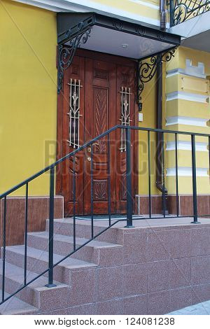 Wooden door with a canopy in a classic style. Architecture