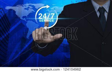 Businessman pressing button 24 hours service icon over map and city tower Full time service concept Elements of this image furnished by NASA