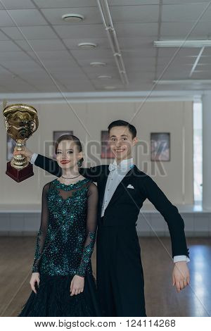 Professional dancers dancing in ballroom. Young couple