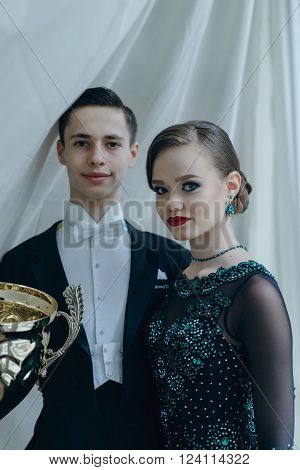 Professional dancers dancing in ballroom. Young couple