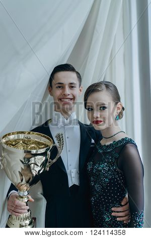 Professional dancers dancing in ballroom. Young couple