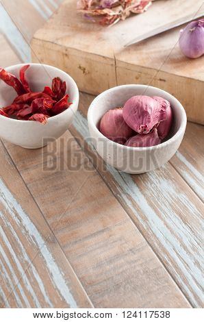 thai seasoning raw ingredient garlic red chill and onion on vintage wood background