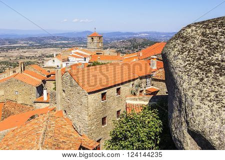background views cityscape Monsanto village with houses made of stone among the boulders and roofs and red brick, the town hall with a clock and a huge boulder
** Note: Visible grain at 100%, best at smaller sizes