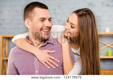 Portrait Of Happy Couple In Love Embracing And Looking At Each Other